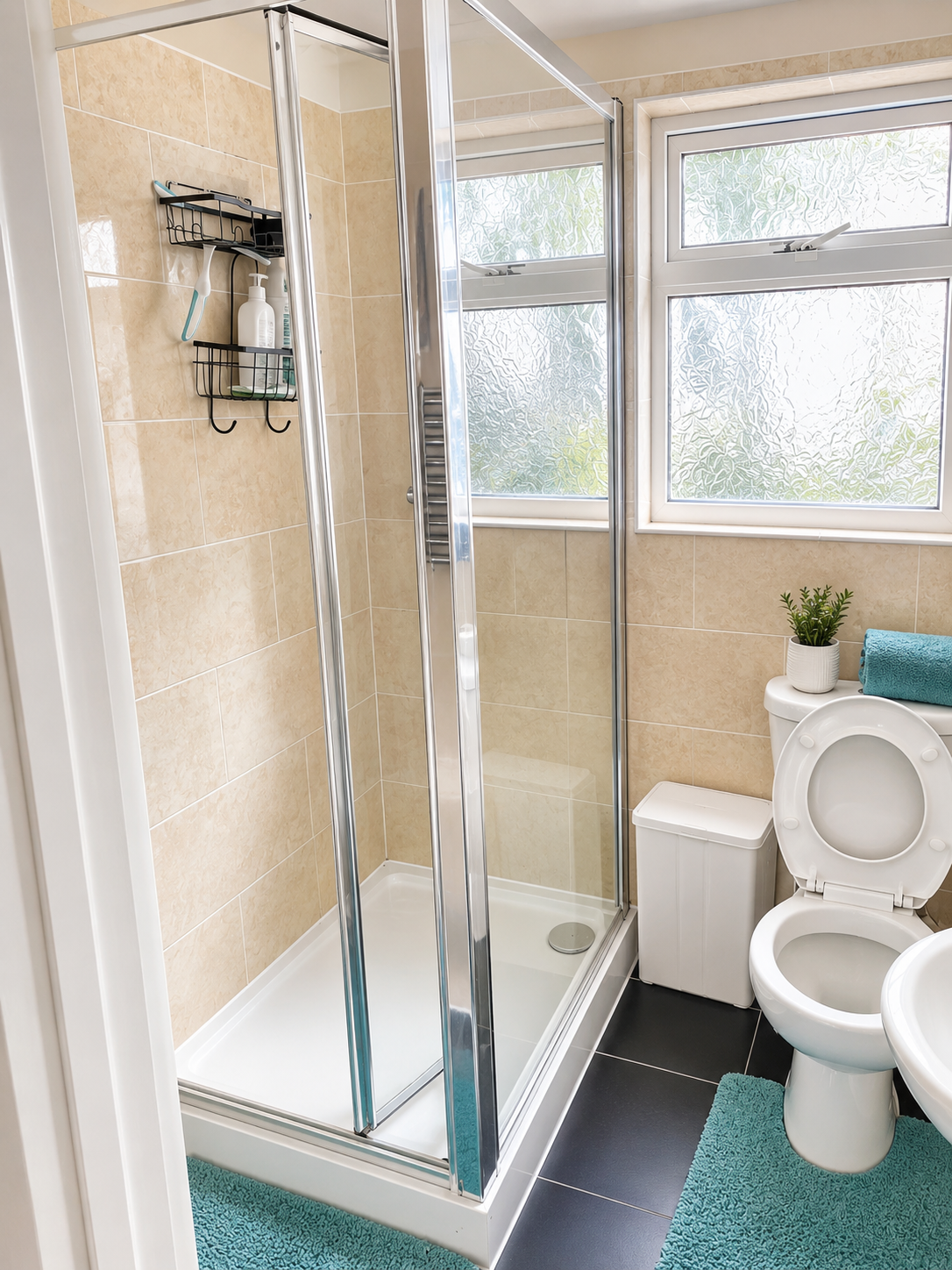 Spotless bathroom with gleaming glass shower enclosure after a Slick Clean service